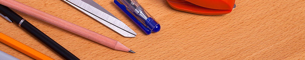 School stationery essentials, exercise books, and colored pencils organized on a desk