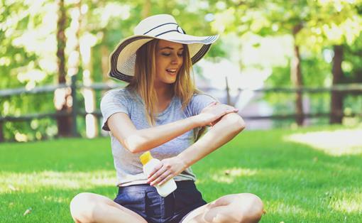 Importance of UV protection: woman applying suncream