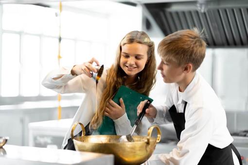Spring recipes: What equipment does your school need?- children cooking together in school kitchen