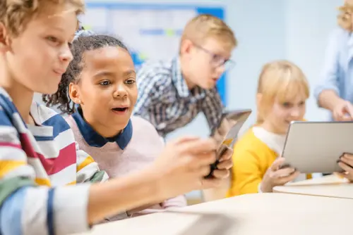 Children on phones in a classroom